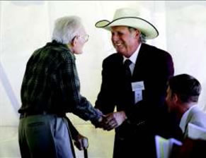 Jose Dodier, right, chairman of the Texas State Soil and Water Conservation Board, shakes hands with Wilson Moon, during the celebration to commemorate the completion of soil mapping on 172 million acres of Texas. The project is part of a national survey that began in 1899. Moon, 99, started with NRCS in 1934 before it became an official agency in 1935. –Photo by Rusty Schramm/Telegram