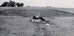 A controlled runoff plot of 1.5 acres on the Blackland Station showing the silt loss measuring devices.